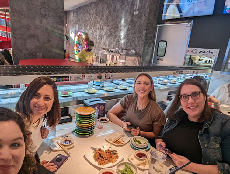 Adtaxi team members at a sushi restaurant together