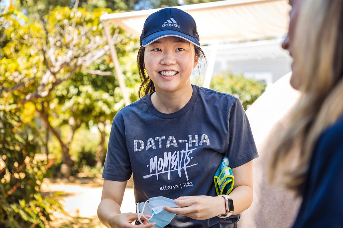 Alteryx team member wearing a company t-shirt at an event outside of work