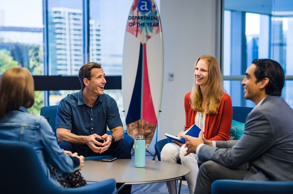 Alteryx colleagues having a team huddle in the office