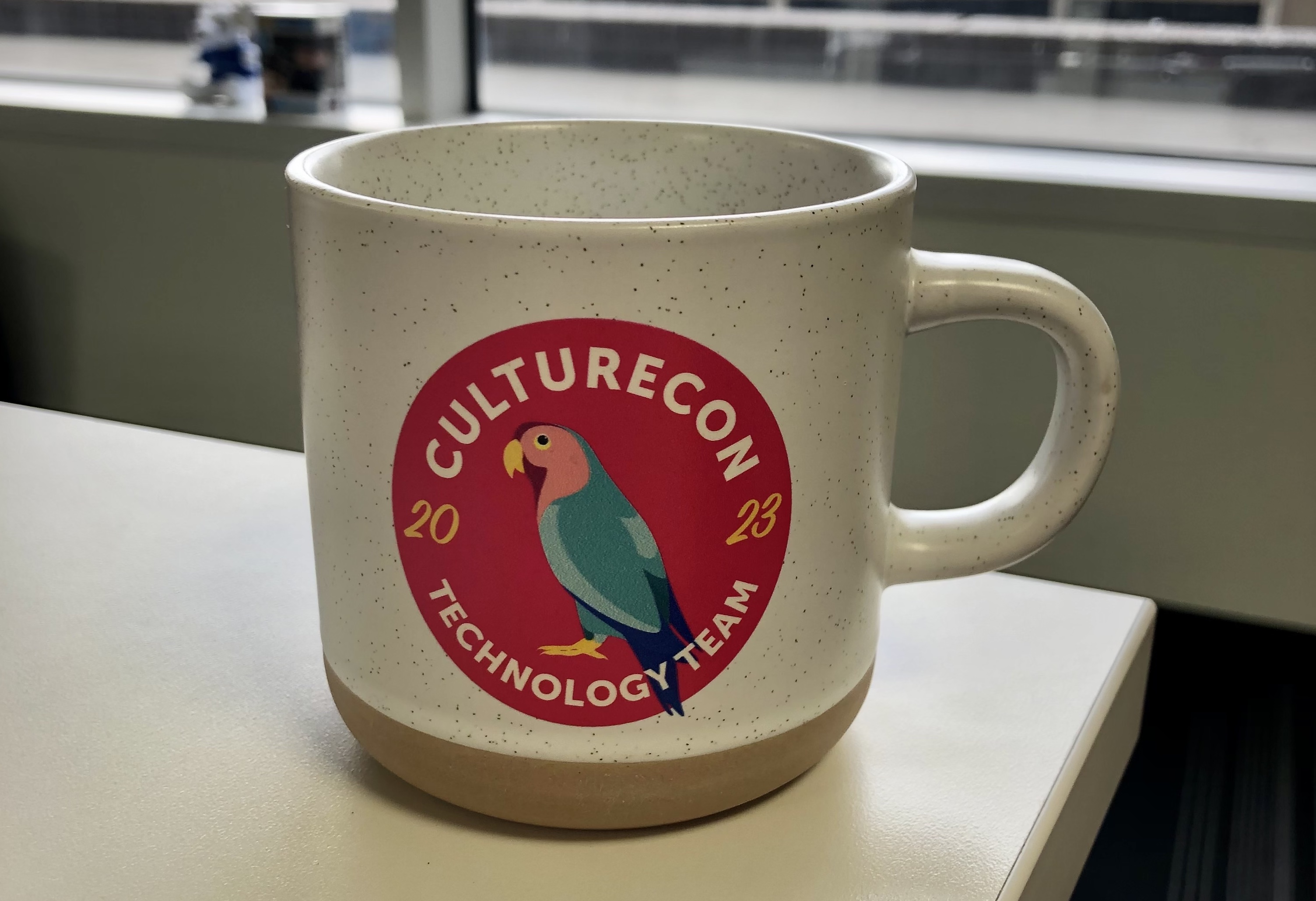 Photo of a mug showing CultureCon's 2023 custom designed logo
