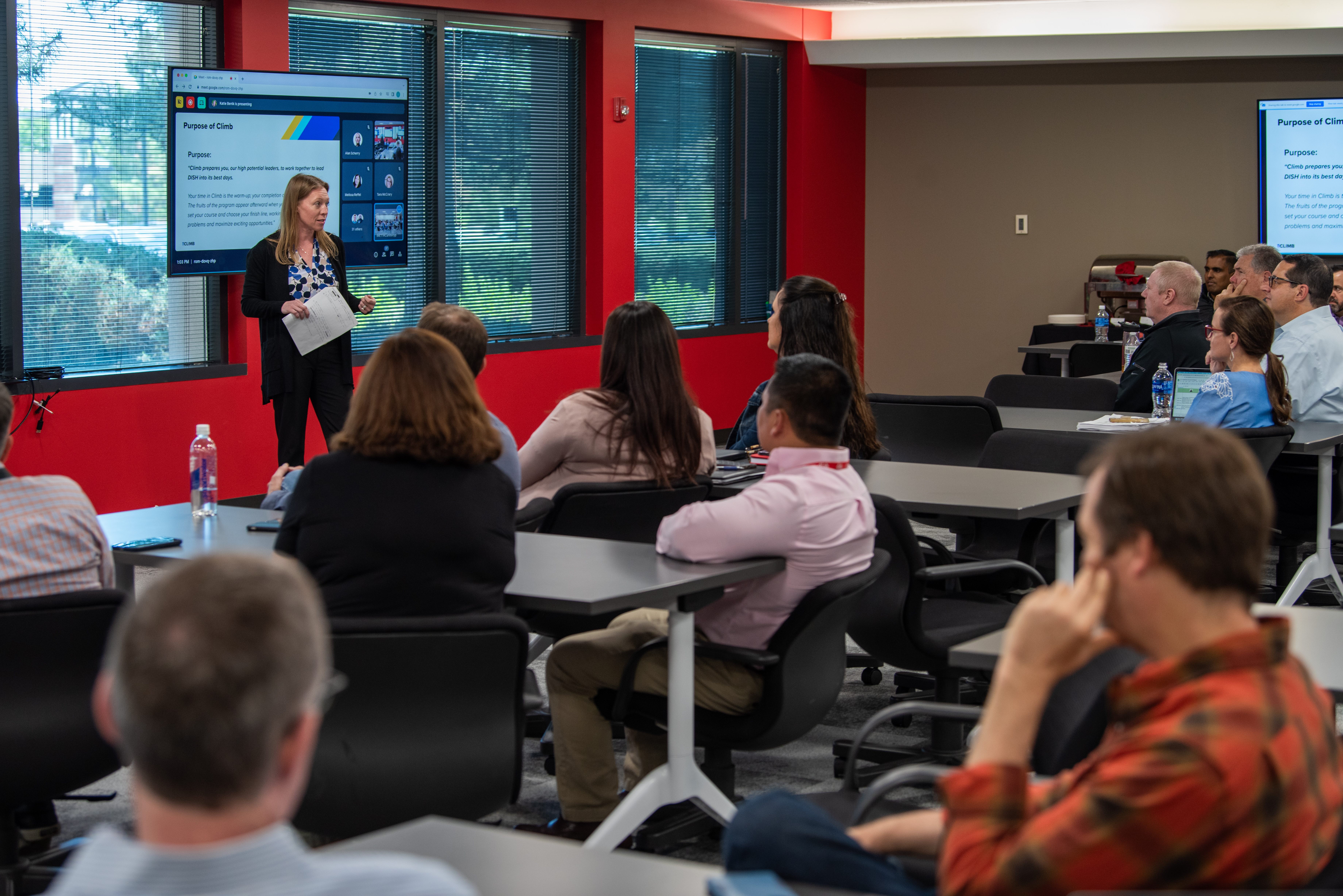 Photo of DISH team members watching a presentation at a professional development event