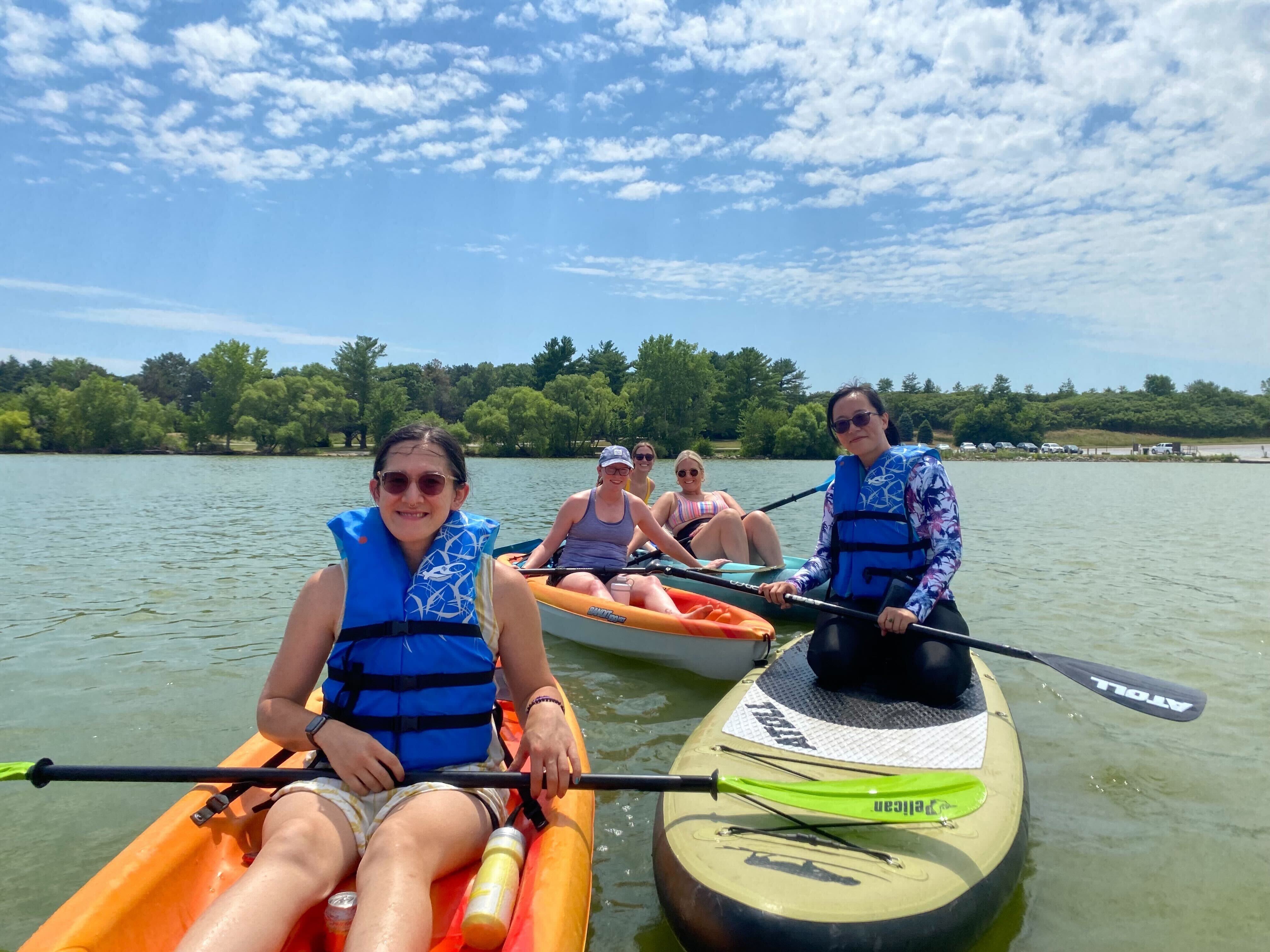 Team members pose for a photo while sitting in kayaks at CamJam, CompanyCam’s yearly company gathering at its headquarters in Lincoln, Nebraska.