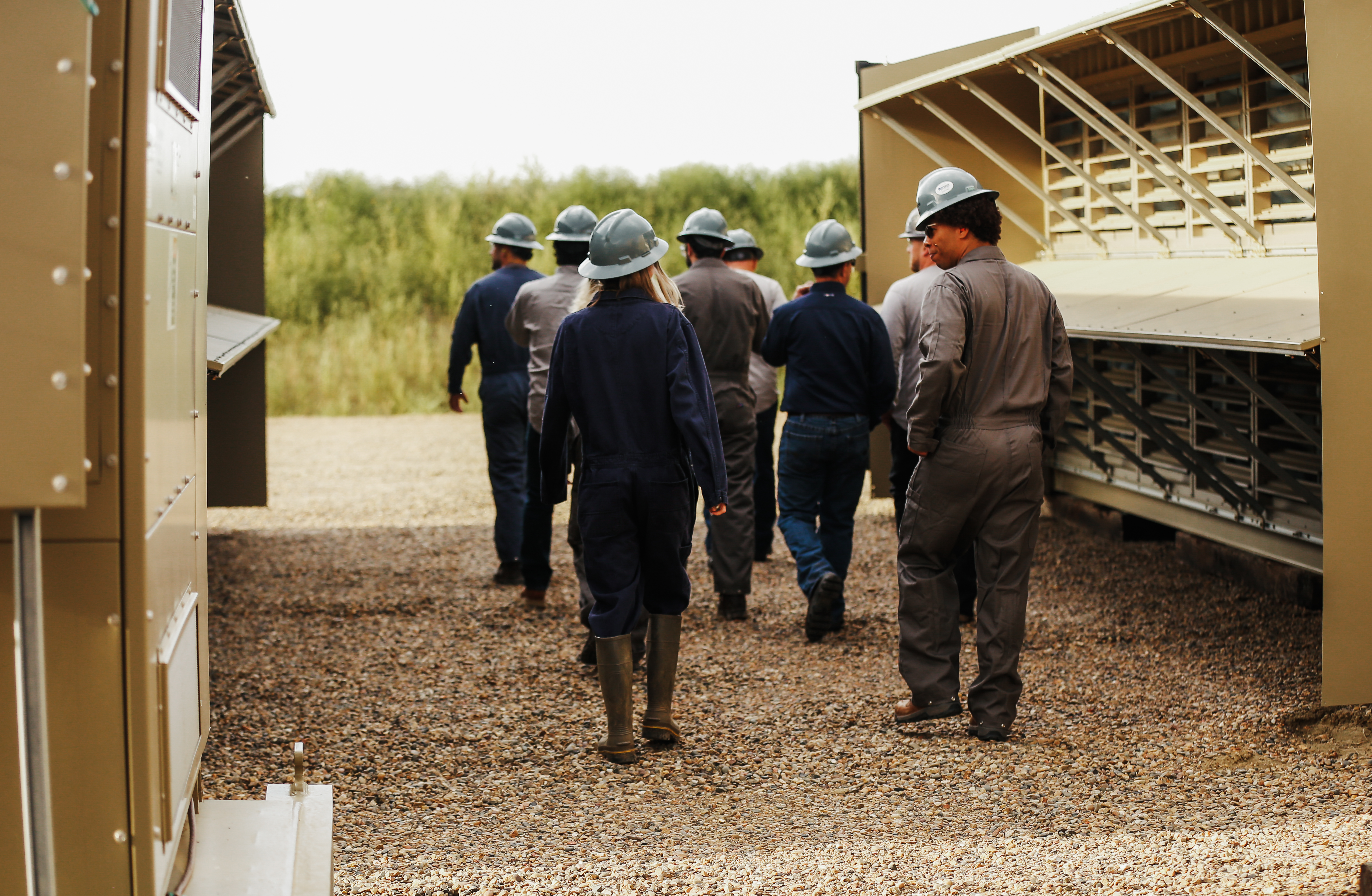 Crusoe Energy Systems staff walking through an outdoor facility 