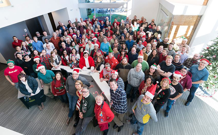 DAT group photo from above with some team members wearing holiday hats