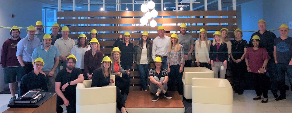 DHI Group team in group photo wearing hardhats
