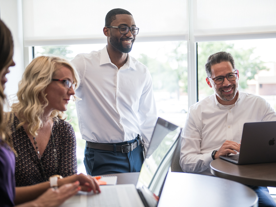 a small team at FirstBank works together at a table