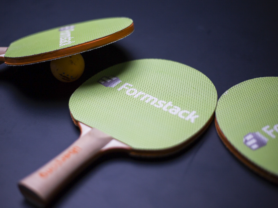 Formstack logo on ping pong paddles