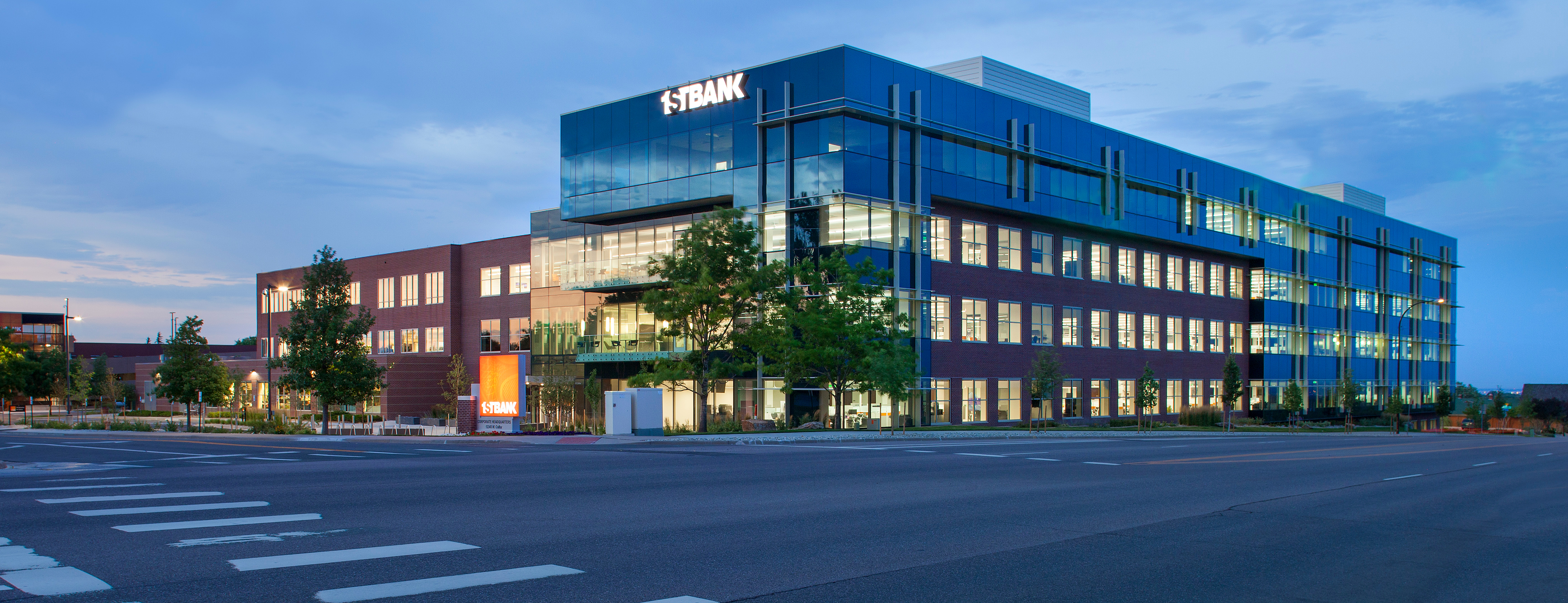 Exterior photo of FirstBank’s corporate headquarters at dusk. 