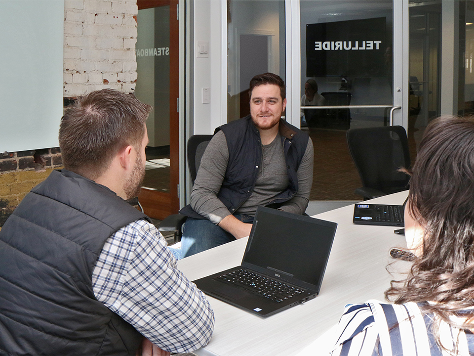 Shawn Leonard laughing with coworkers