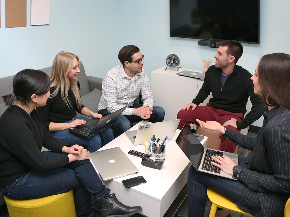 The team at Healthgrades, collaborating in the office