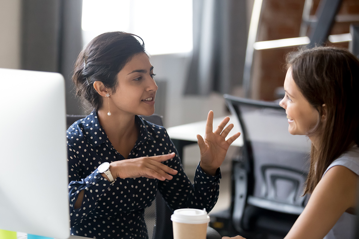 Two colleagues having a conversation in the workplace