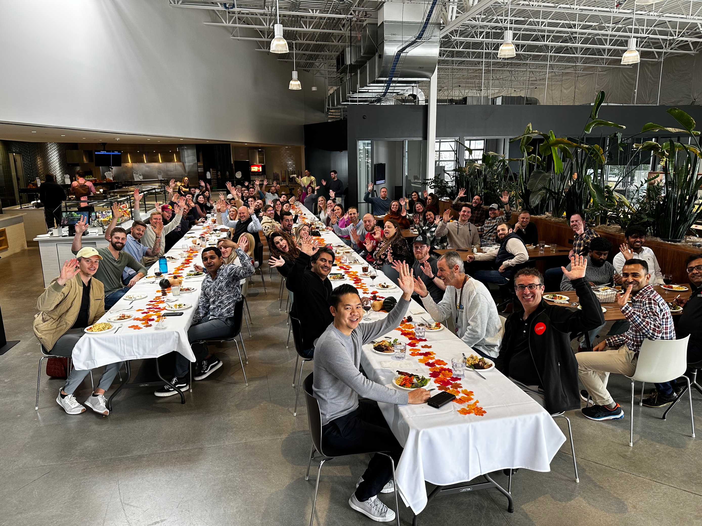 Conga's team shares a meal at long tables