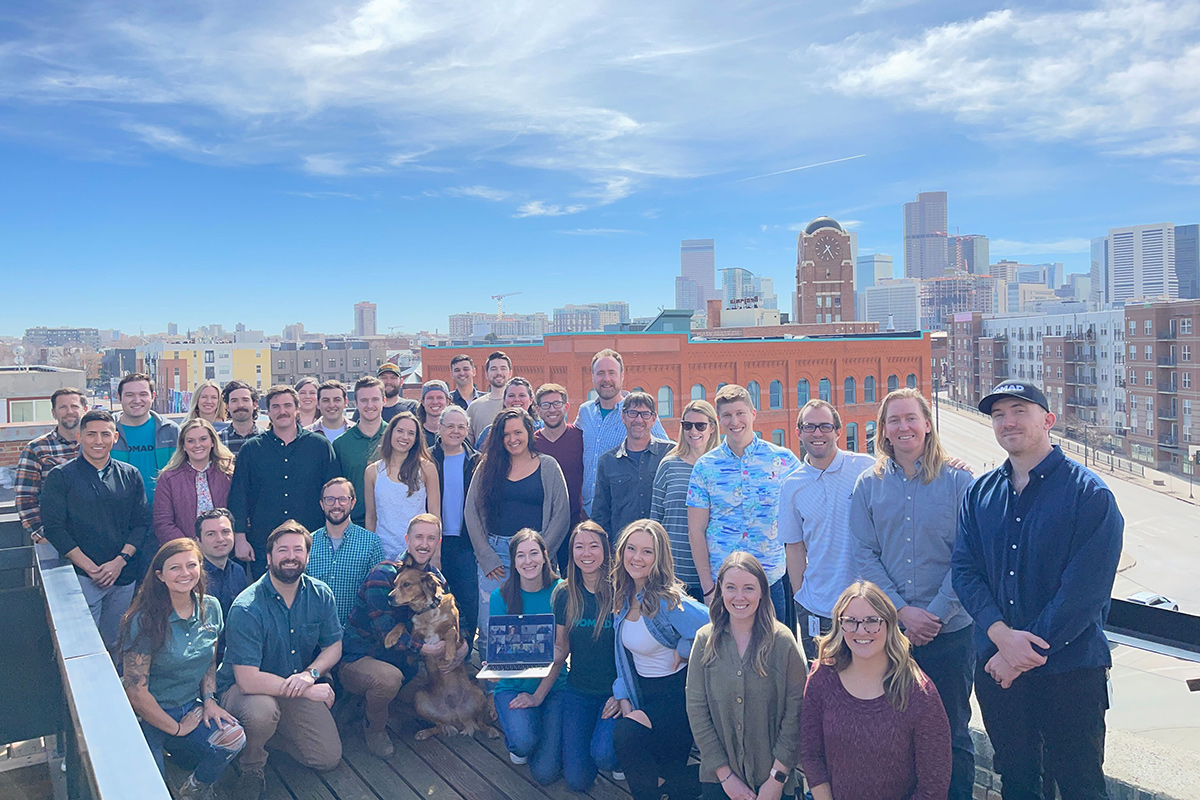 Nomad team photo on a rooftop deck