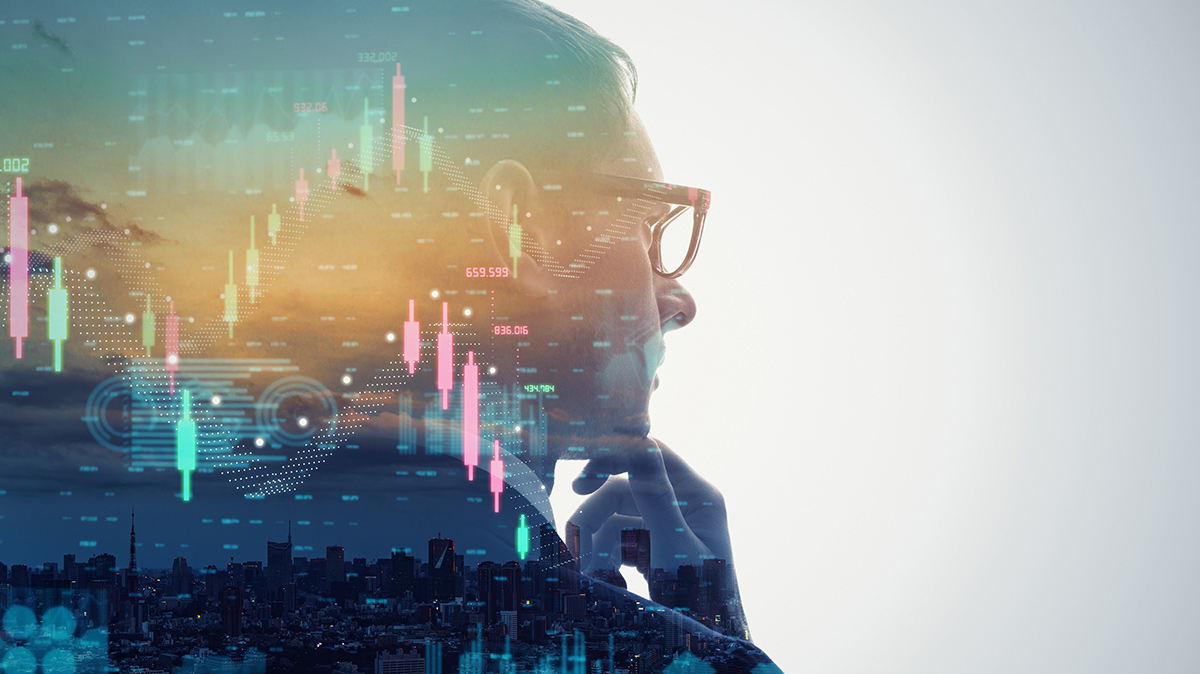 Profile view of a businessman concentrating double exposed with investment charts