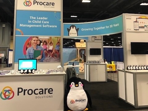 Photo of Procare Solutions’ booth at an expo, featuring Tucker the penguin 