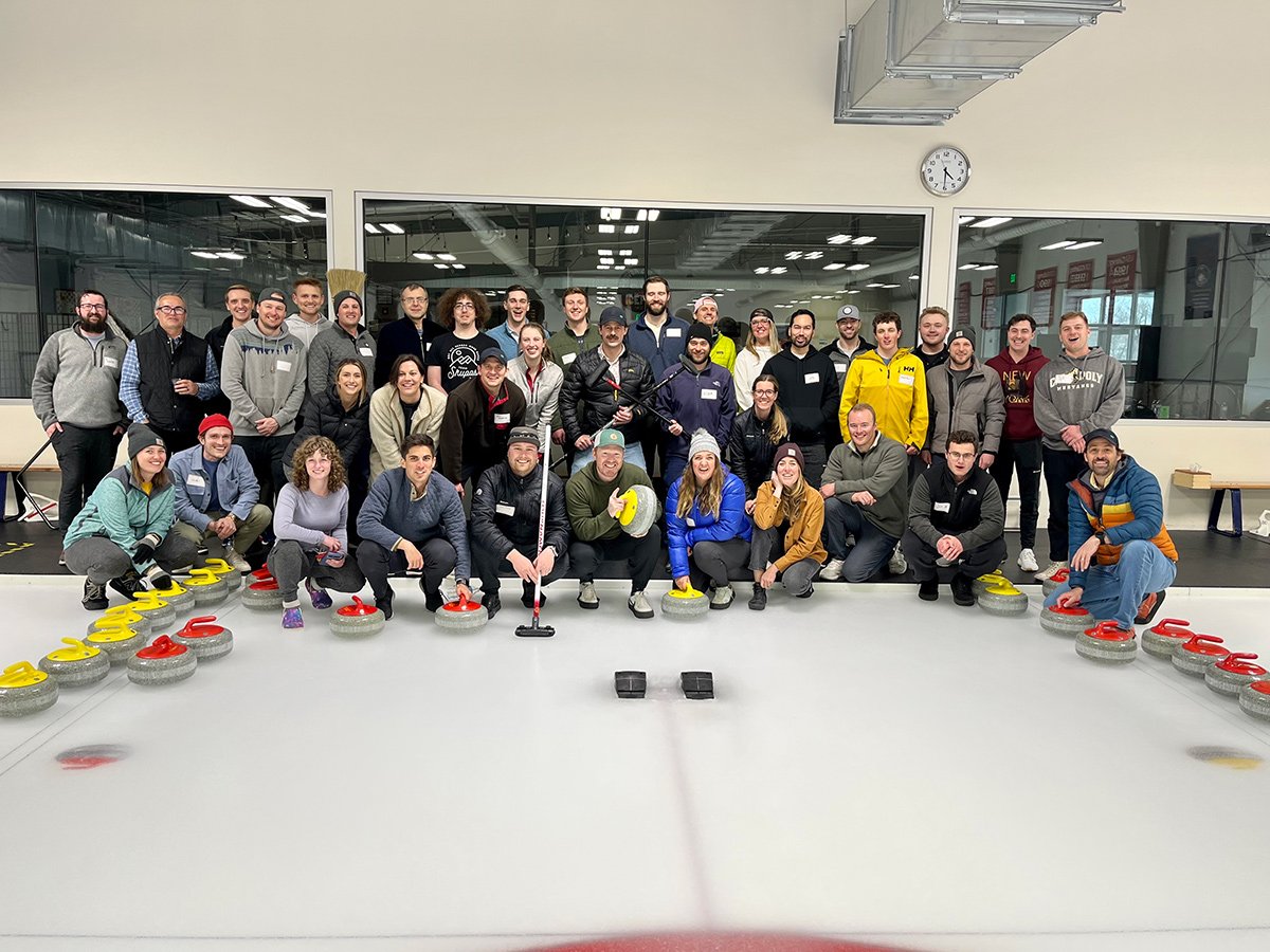 Skupos group photo on a curling ice rink