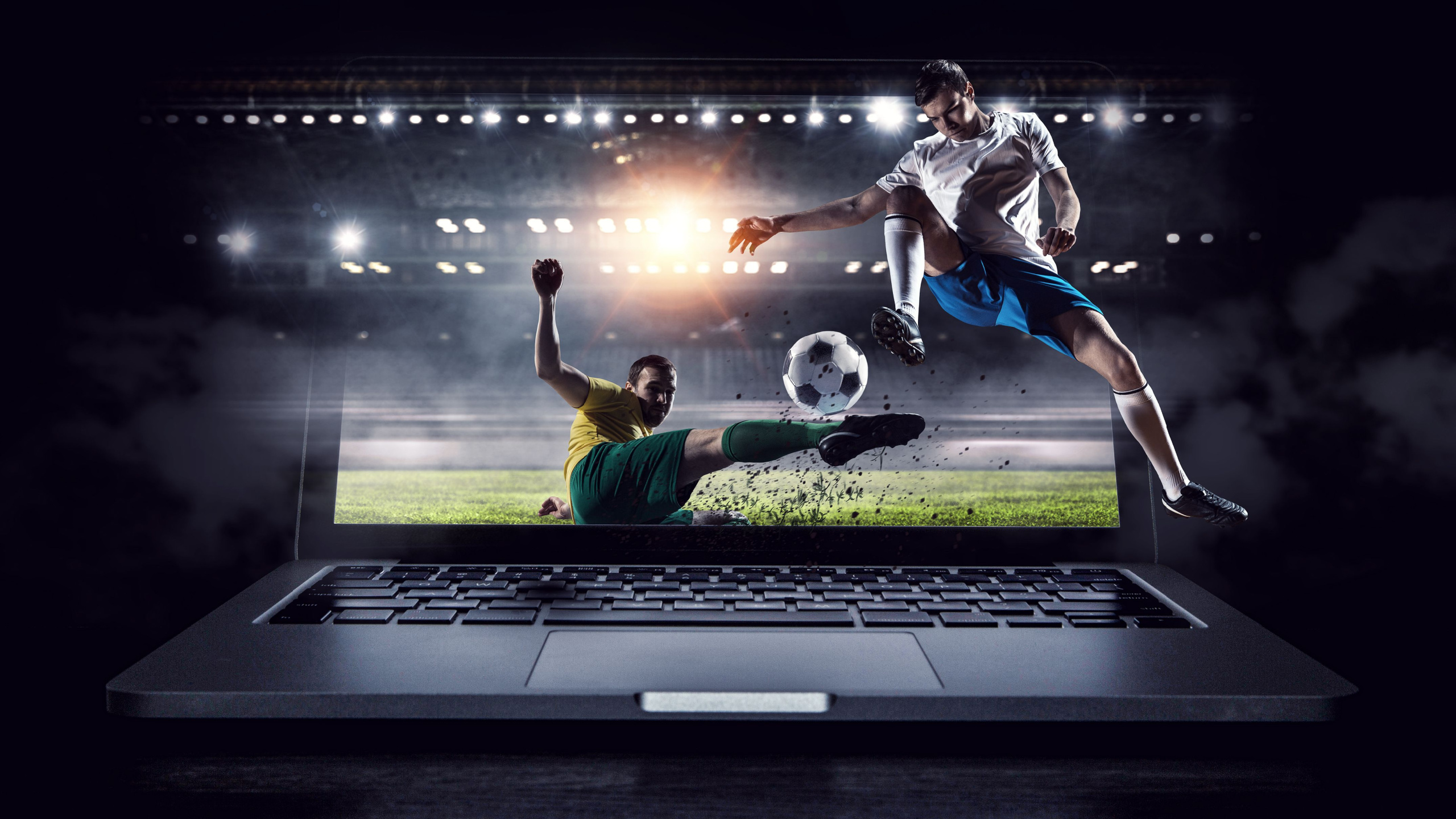 A soccer game plays on a laptop. 