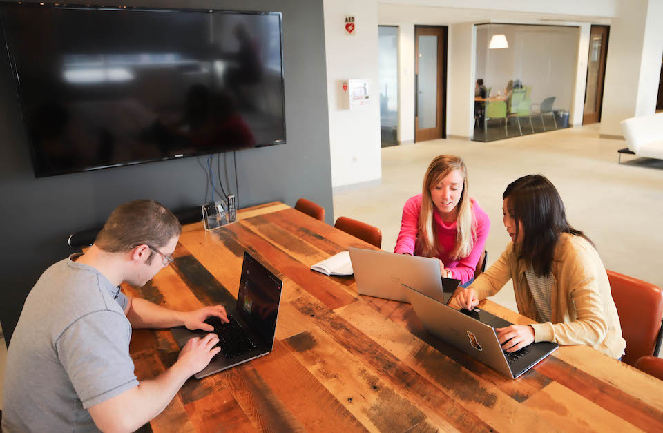 SpotX team members working in their office