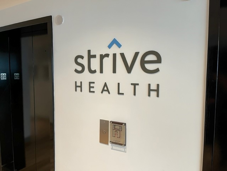 Strive Health logo on th ewall in the office