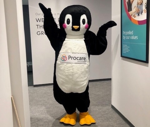 Photo of a person dressed up as Tucker, the penguin mascot of Procare Solutions