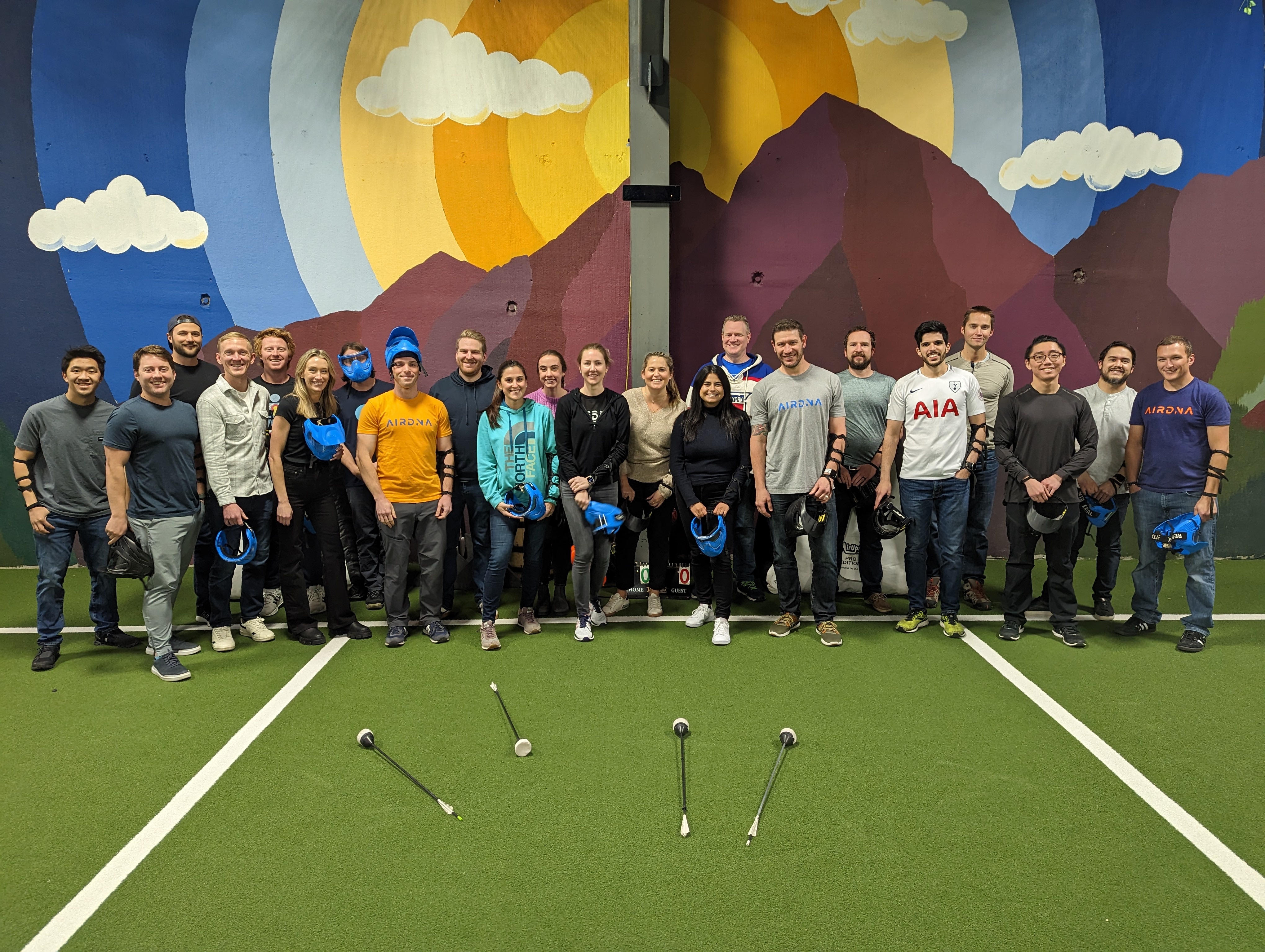 Members of the AirDNA team participate in a team building activity in a sports center.
