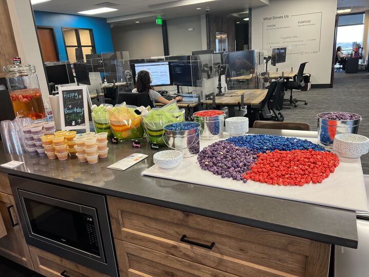 Photo of a countertop full of food, including a display of colored popcorn.