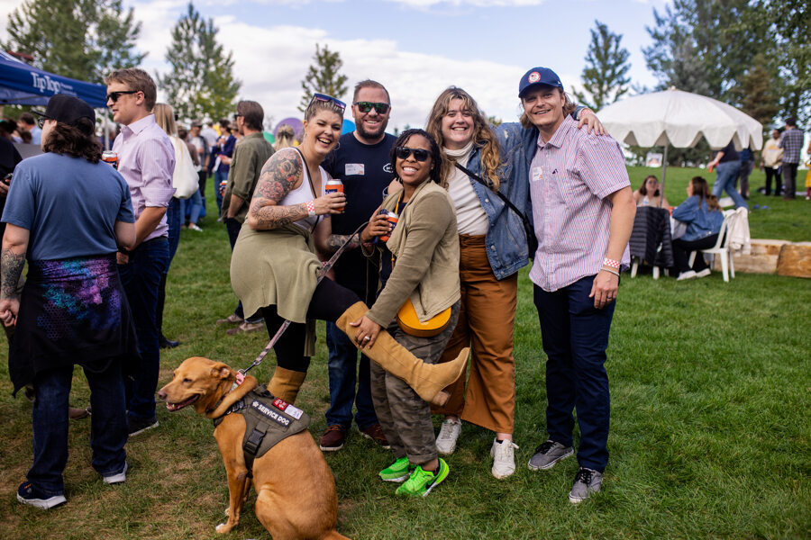 Group of five Pax8 team members and one dog pose for picture at outdoor company picnic.