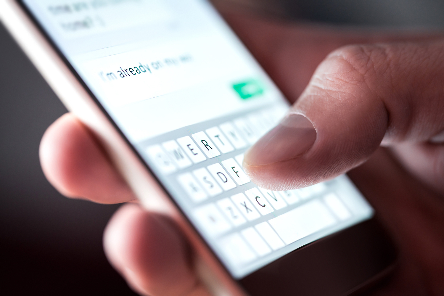 A close-up image of someone text messaging.
