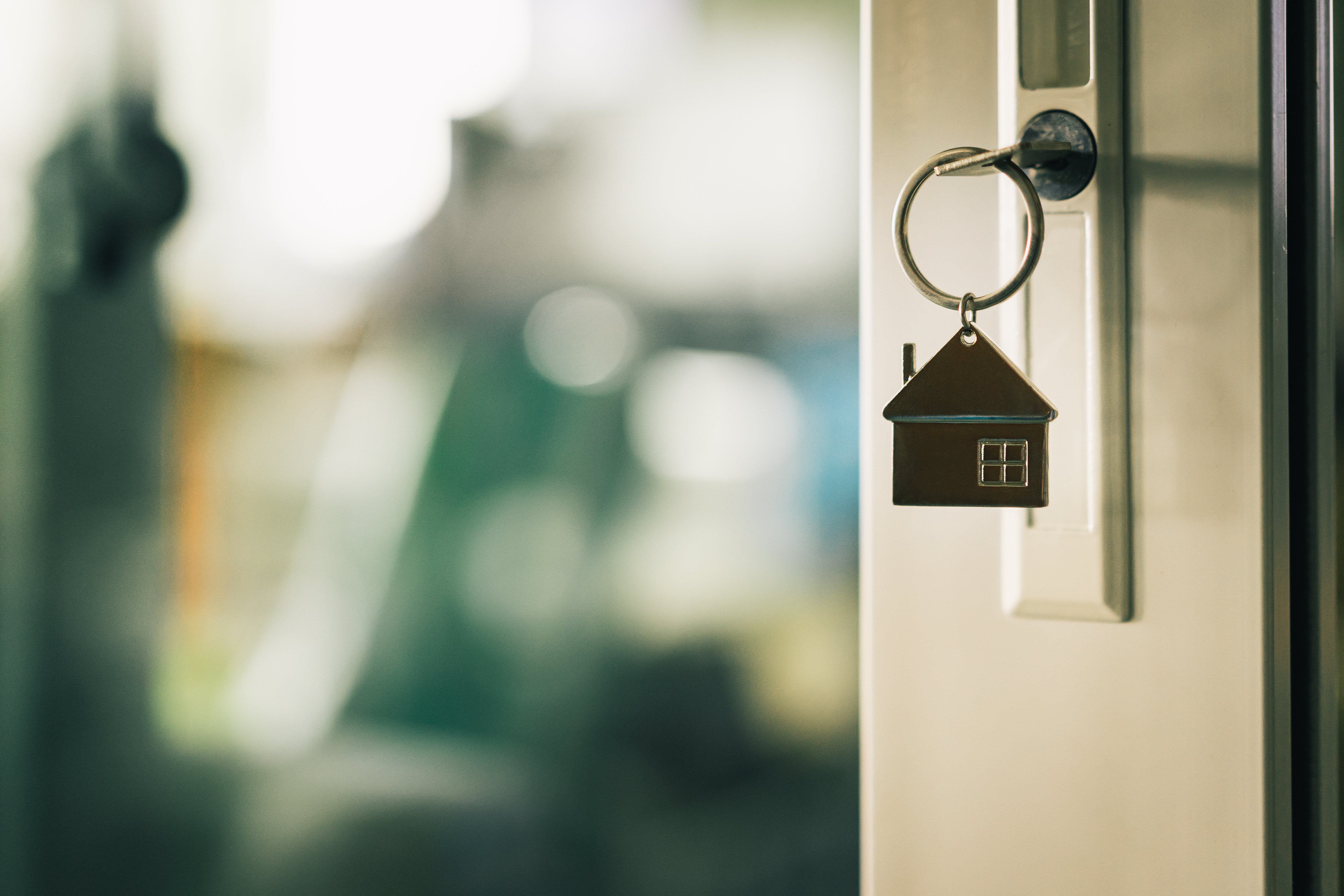 A key hangs from a rental home door. 