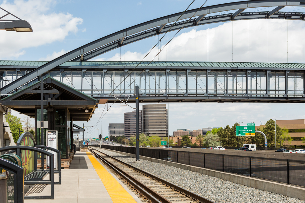 Lightrail tracks and a pedestrian bridge above a highway in the Denver Tech Center.