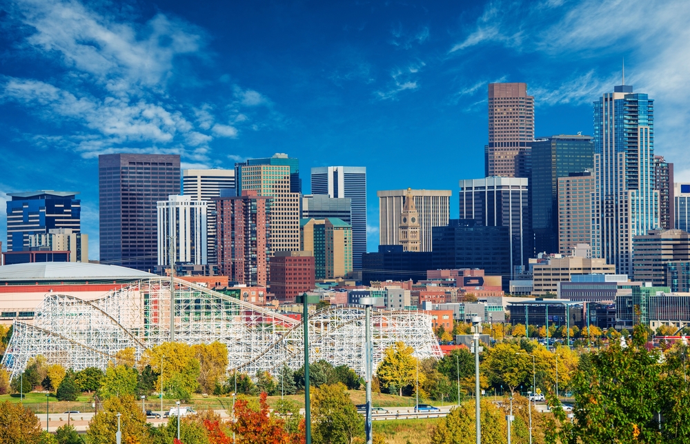 Downtown Denver during the day with Elitch Gardens in the foreground.