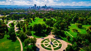 a park with the denver skyline in the background