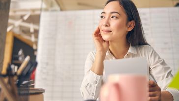 Photo of a person looking contentedly off to the side in an office.