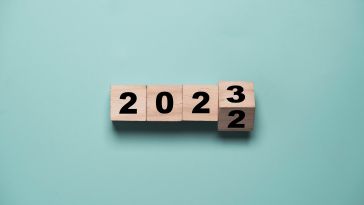 Four wooden number blocks, spelling out 2022 turning into 2023.