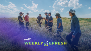 The Mad Capital team talking with farmers in a field.