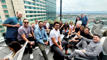 Quantive staff on a rooftop overlooking the city.