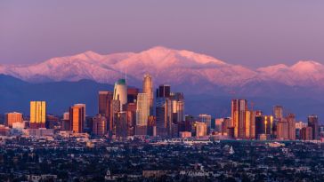 The Denver skyline with the Rocky Mountain in the background.