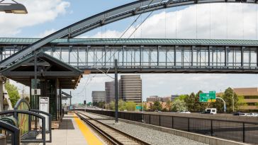 Lightrail tracks and a pedestrian bridge above a highway in the Denver Tech Center.