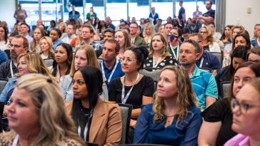 Photo of audience of DISH employees at a large presentation