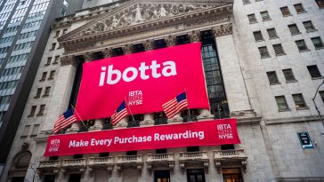 A banner bearing Ibotta's logo is shown draped over the New York Stock Exchange building.