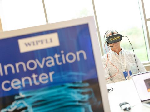 Wipfli team members attending a summit where they test VR headsets and handheld devices.