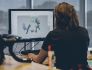 A person faces a computer while designing bicycle parts