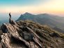 A photo depicting a person on a journey, climbing through a mountainous area.